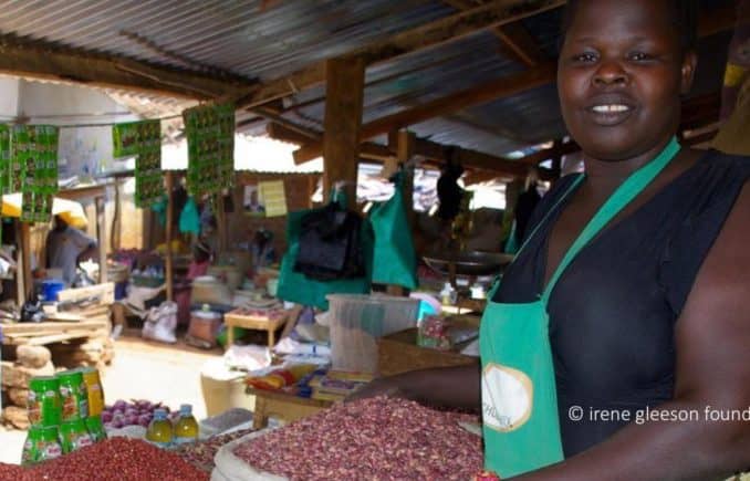 Photo of African woman selling goods in a market stall