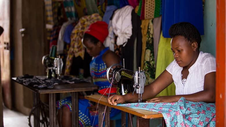 Photo of African women sewing at machines in workshop