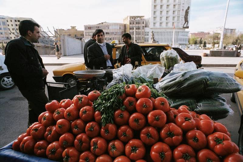 Photo of men buying and selling fresh fruit and vegetables on the roadside