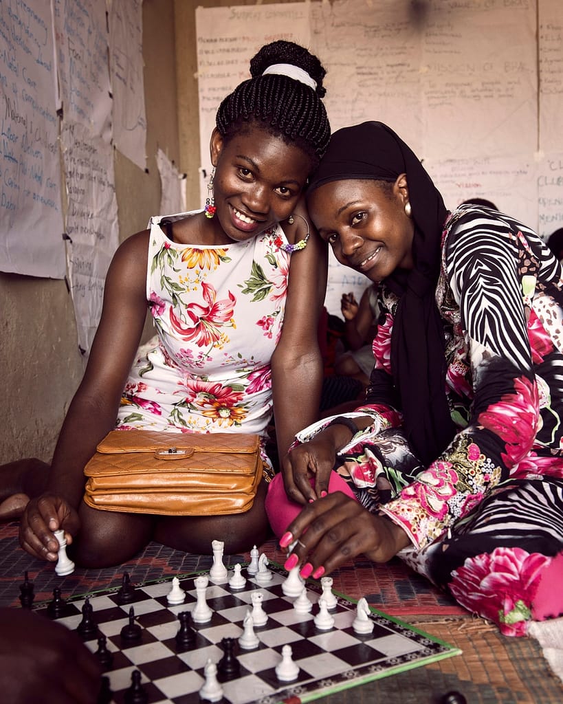 Two black young women playing chess