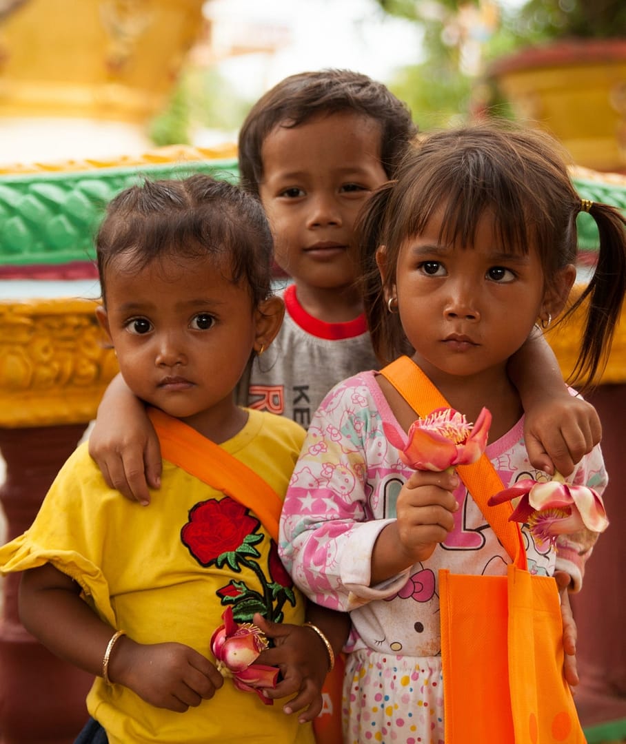 Small Southeast Asian Children Holding Flowers