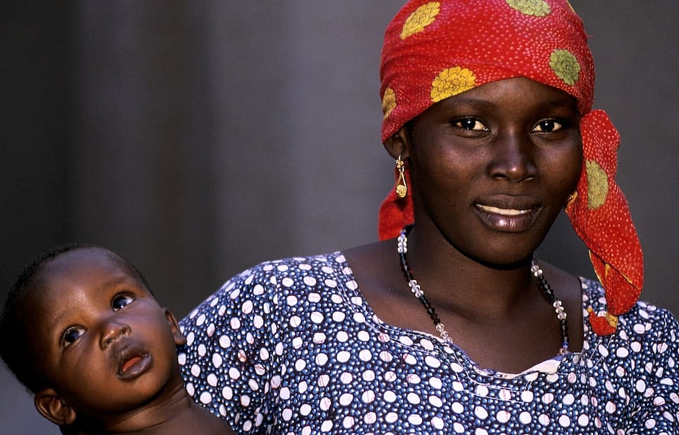 Photo of African woman holding a young child