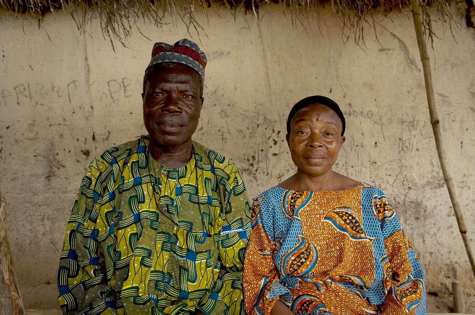 Photo of older African man and woman looking at camera