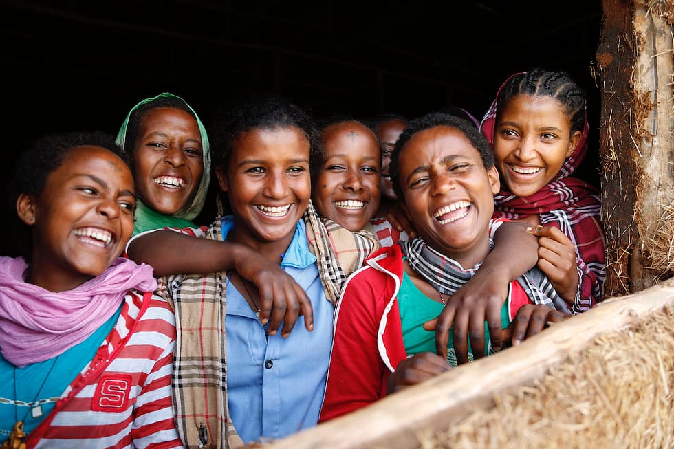 A group of young women in Ethiopia smiling and laughing